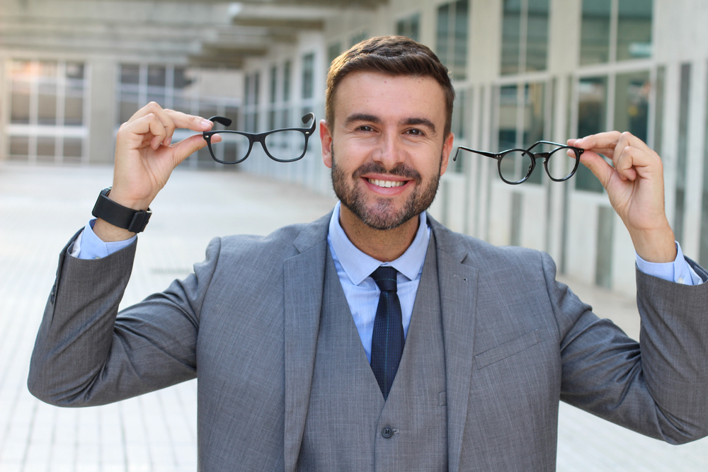 Happy,Man,Holding,Two,Pairs,Of,Glasses