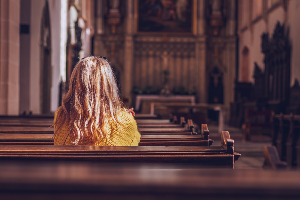 Young,Woman,Praying,And,Meditating,In,Church.,Belief,In,Jesus